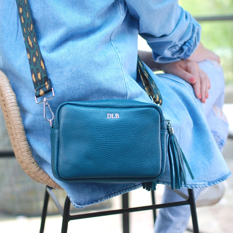 Teal Leather Crossbody Bag with Teal Camo strap shown on a model