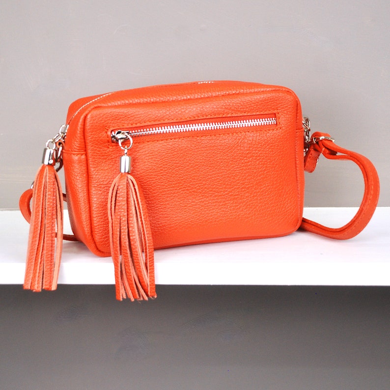 Monogram Leather Crossbody Bag in Orange  shown close up.