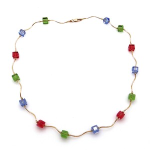 May include: A gold chain necklace with alternating blue, green, and red square beads.