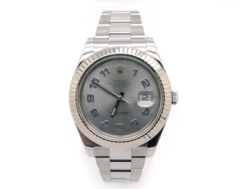 May include: A silver Rolex Oyster Perpetual Datejust watch with a silver face and blue Roman numeral hour markers. The watch has a date window at the 3 o'clock position.