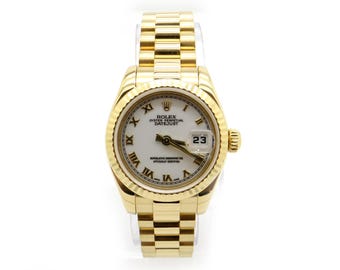 May include: A gold Rolex Oyster Perpetual Datejust watch with a white face, Roman numeral hour markers, and a date window at the 3 o'clock position.