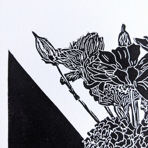 Detail of bold black and white original linoleum block print of floral still life bouquet in a patterned vase.