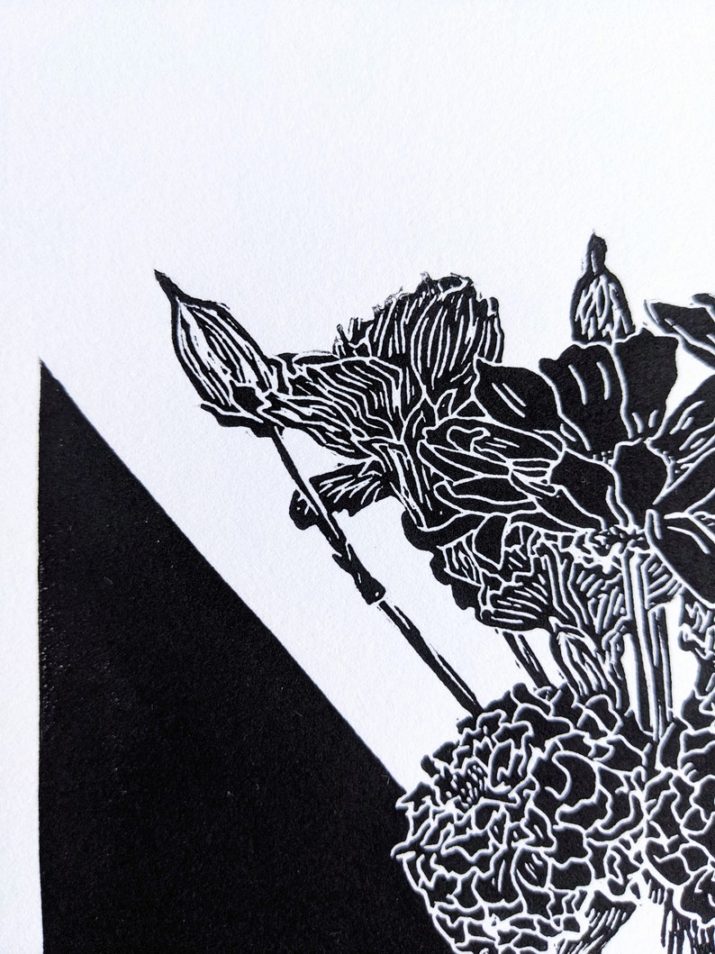 Detail of bold black and white original linoleum block print of floral still life bouquet in a patterned vase.