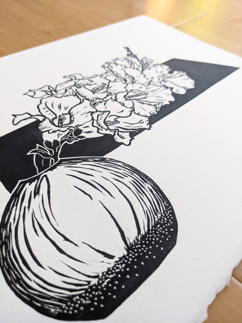 Detail of original linoleum block print chantilly light snapdragon floral still life in a small round vase.