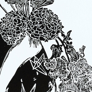 Detail of bold black and white original linoleum block print of floral still life bouquet in a patterned vase.
