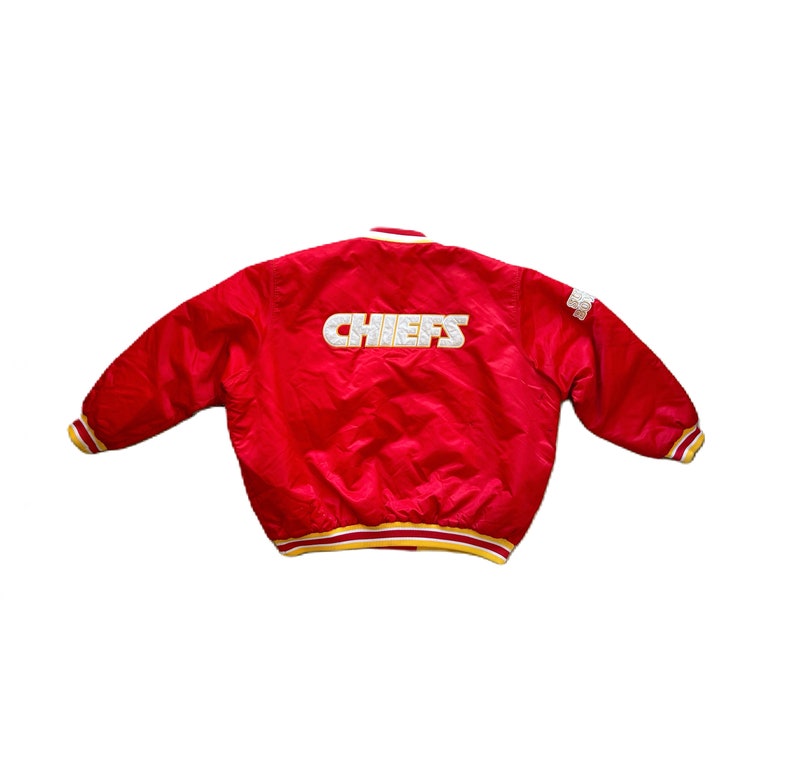 May include: Red satin bomber jacket with a white "CHIEFS" logo on the back. The jacket has yellow and white stripes on the cuffs and waistband.