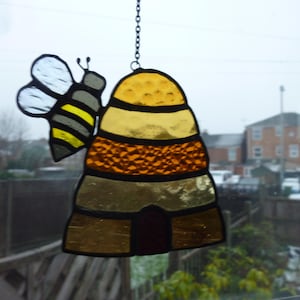 Beehive suncatcher.Honeycomb suncatcher. Hive with Bee.
