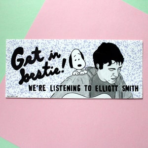 May include: A black and white sticker with a cartoon of a man with a guitar and a cartoon dog. The text on the sticker reads "Get in bestie! We're listening to Elliott Smith."