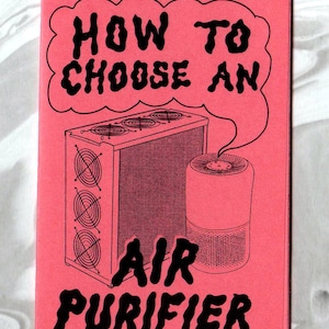 May include: A rectangular pink booklet with black line art illustrations of two different air purifier models. The text on the cover reads, "HOW TO CHOOSE AN AIR PURIFIER," with the words enclosed in a speech bubble graphic above the devices.
