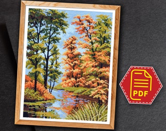 May include: A cross-stitch pattern featuring a scenic landscape with a river flowing through a forest. The trees are a mix of green and orange, with the leaves changing color for autumn. The river reflects the colors of the trees and the sky.