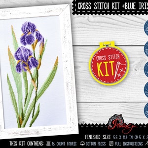 May include: Cross stitch kit featuring a design of blue irises in a white frame. The kit includes 16 count fabric, cotton floss, full instructions, and a needle. The finished size is 5.5 inches by 11.4 inches.