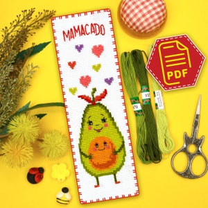 May include: Cross stitch pattern for a bookmark featuring a cartoon avocado with a smaller avocado inside, surrounded by hearts. The pattern is titled "Mamacado" and is available as a PDF download.