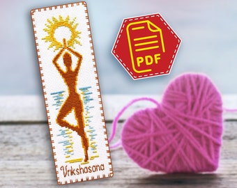 May include: A cross-stitch bookmark featuring a woman in a yoga pose called Vrikshasana, or Tree Pose, with a sun behind her. The bookmark is white with orange, yellow, and blue accents.