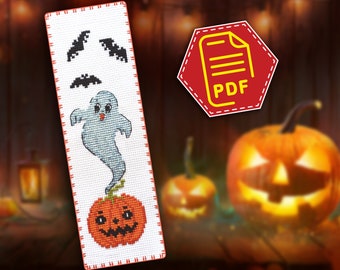 May include: A cross-stitch bookmark featuring a ghost, bats, and a jack-o'-lantern. The bookmark is white with red stitching around the edges. The ghost is light blue and has a friendly face. The bats are black and the jack-o'-lantern is orange with a black face.