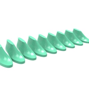 May include: A set of nine mint green shoe lasts arranged in a diagonal line. Each shoe last features a smooth, solid surface with a rounded toe and a raised heel section, designed to maintain the shape of footwear during the manufacturing process.