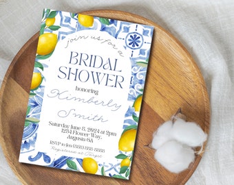May include: A bridal shower invitation featuring a watercolor design with lemons and blue tile patterns. The invitation includes the text "Join us for a Bridal Shower honoring Kimberly Smith" and event details. The invitation is on a wooden tray.