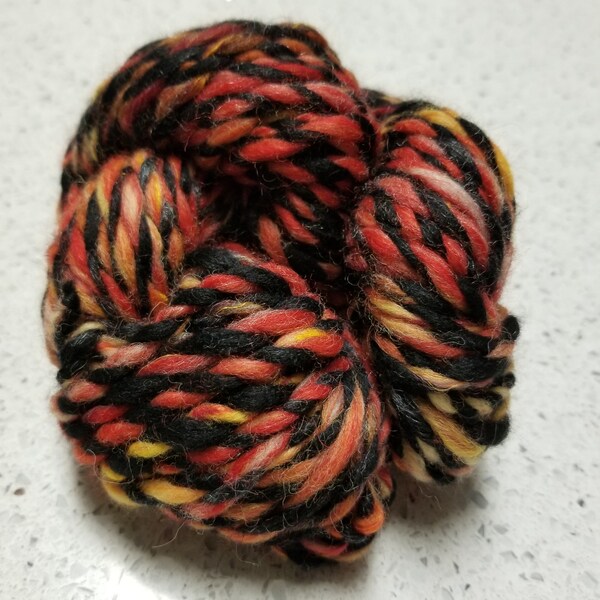 Red, Orange, yellow and black drop spindle spun wool yarn 2oz