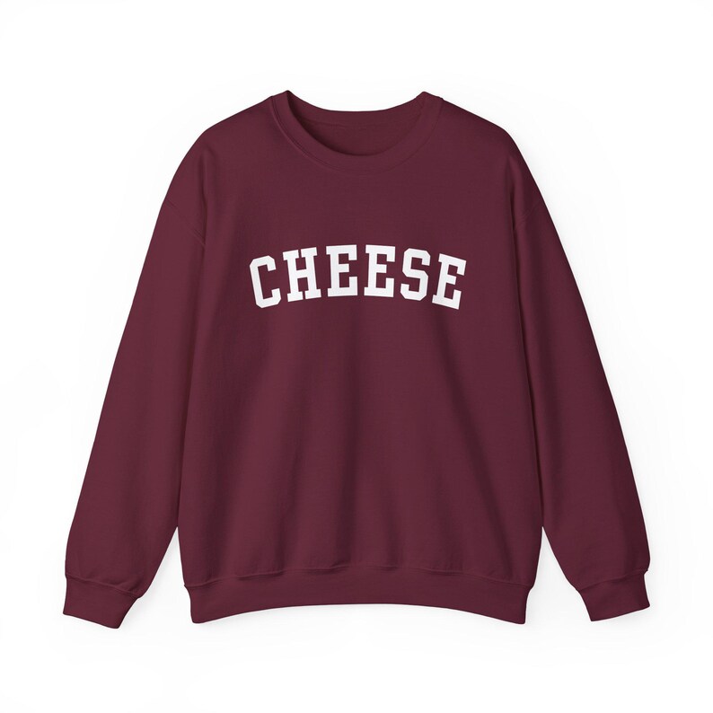 May include: Burgundy sweatshirt with the word "CHEESE" printed in white in a collegiate font.