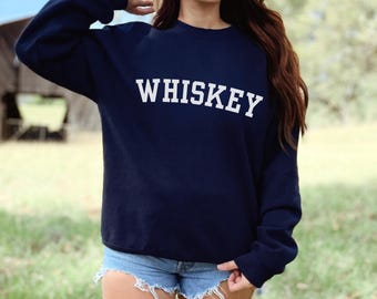 May include: A navy blue sweatshirt with the word "WHISKEY" printed in white on the front.