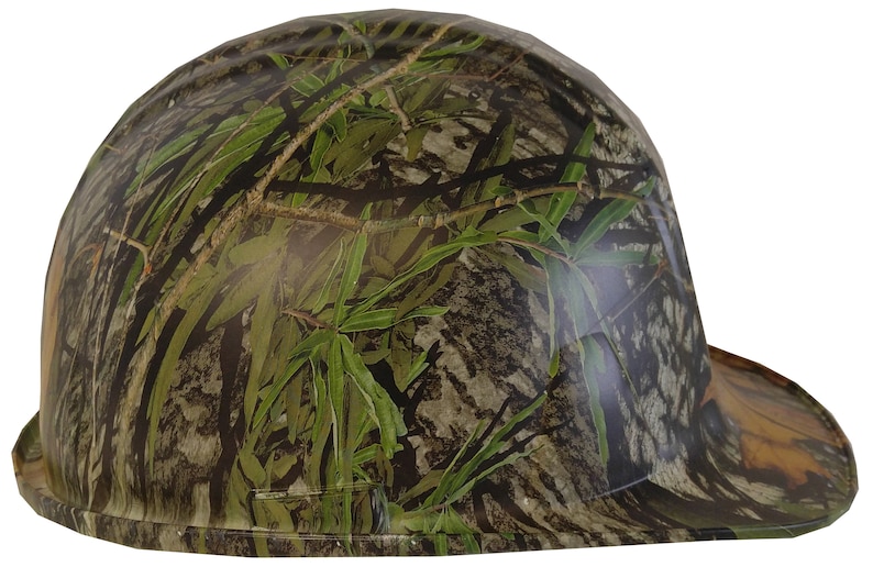 May include: A camouflage hard hat with a flat brim. The hat is green, brown, and black with a leafy pattern.