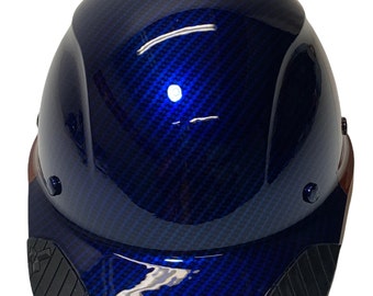 Può includere: Un casco blu con un motivo in fibra di carbonio e una visiera nera. Il casco ha una fascia marrone intorno alla base e una visiera in gomma nera.