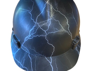 May include: A black hard hat with a white lightning bolt pattern. The hard hat has a brim and a suspension system.
