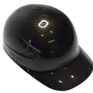 May include: A black carbon fiber hard hat with a baseball cap brim. The hat has a ventilation system on the side.