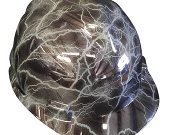 May include: A black hard hat with a white lightning bolt pattern. The hard hat has a brim.