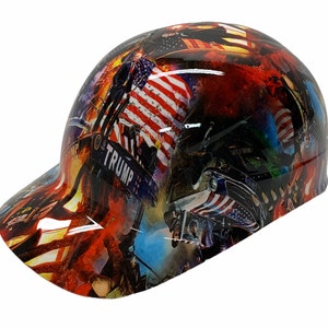 May include: A hard hat with a red, white, and blue American flag design. The hat has a black brim and the words "TRUMP" are visible on the side.