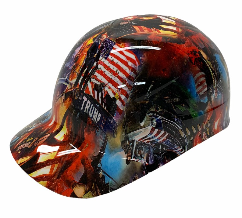 May include: A hard hat with a red, white, and blue American flag design. The hat has a black brim and the words "TRUMP" are visible on the side.