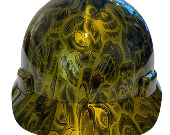 May include: A yellow hard hat with a skull and crossbones design.