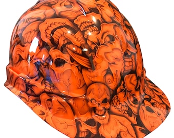 May include: Orange hard hat with a skull and crossbones design. The hat is covered in a pattern of skulls and bones.