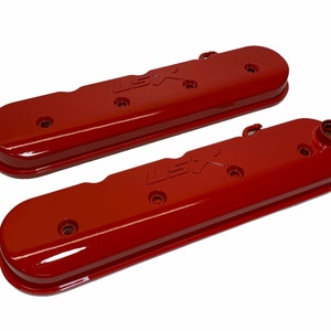 May include: A pair of red engine valve covers with the text "LS7" embossed on the top.