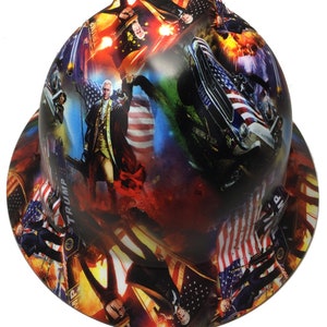 May include: A hard hat with a patriotic design featuring the American flag, historical figures, and a vintage car. The hat has a wrap-around print with a mix of red, white, blue, and other colors.