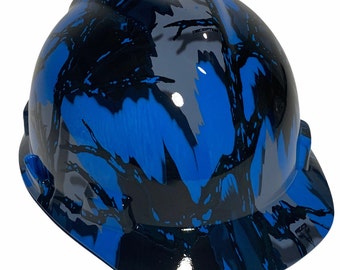 May include: A blue, black, and gray hard hat with a camouflage pattern. The hard hat has a brim.