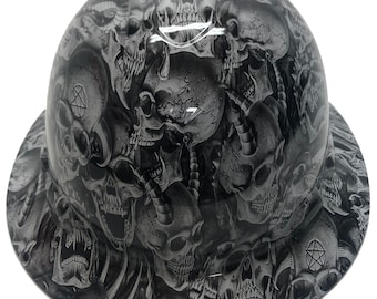 May include: A black and white hard hat with a skull pattern. The pattern features multiple skulls with different expressions and details.