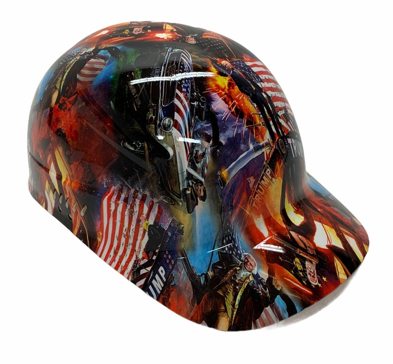 May include: A hard hat with a patriotic design featuring the American flag, images of presidents, and other patriotic imagery. The hat is black with a red, white, and blue design.