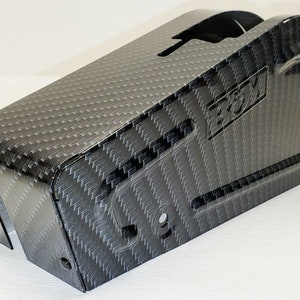 May include: Black carbon fiber gear shift cover with the word "ECM" embossed on the side.