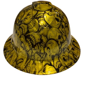 May include: A yellow hard hat with a skull pattern. The hat is covered in a black and white skull design.