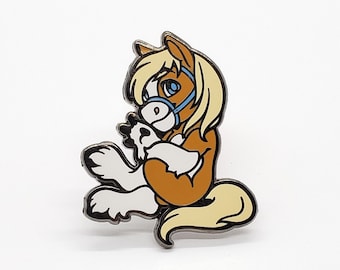 May include: A brown and white horse with a blue bridle, sitting on its haunches with its head turned to the side. The horse has a blonde mane and tail. The horse is a cartoon style enamel pin.