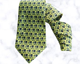 May include: A yellow silk tie with a repeating pattern of black and blue lions and elephants.