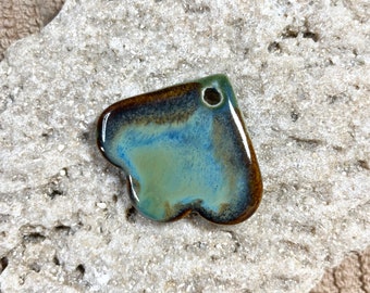 May include: A blue, green, and brown ceramic heart-shaped pendant with a hole at the top for hanging.