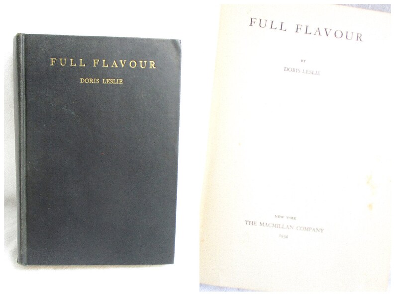 May include: A black hardcover book titled "Full Flavour" by Doris Leslie. The book cover has gold lettering. The back cover of the book is white with the text "Full Flavour" by Doris Leslie. The text "The Macmillan Company" is printed on the back cover.