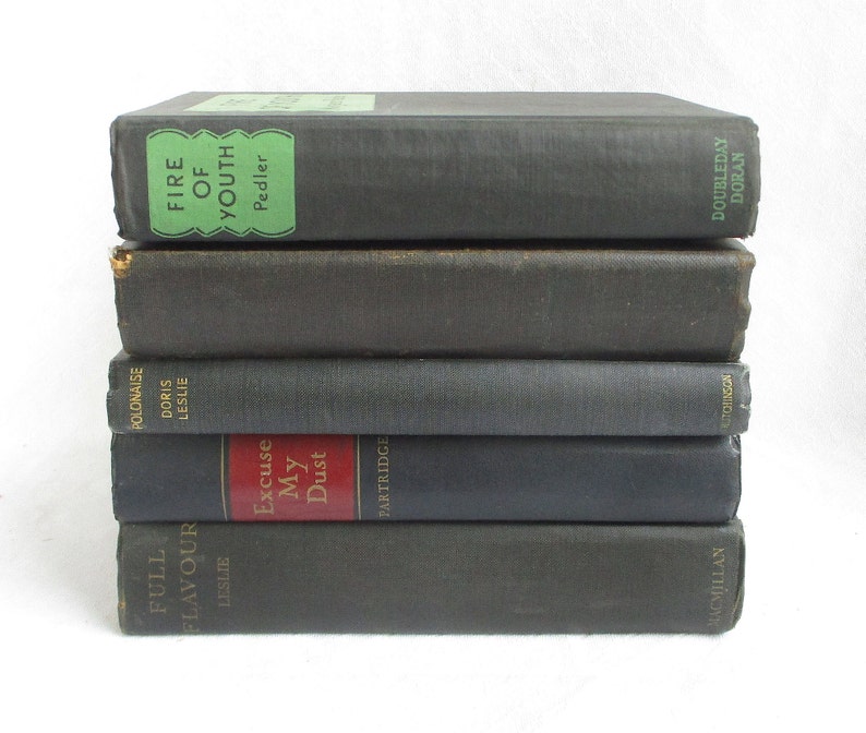May include: A stack of six vintage hardcover books with black covers and gold lettering. The titles include "Fire of Youth", "Polonaise", "Excuse My Dust", and "Full Flavour".