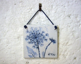 handmade decorative tile, "4 You" with patinated imprints of the "Wild Carrot", handcrafted ceramic tile in white and blue