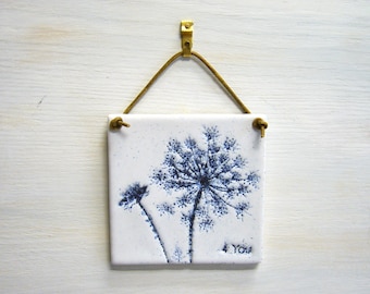 handmade decorative tile, &quot;4 You&quot; with patinated imprints of the &quot;Wild Carrot&quot;, handcrafted ceramic tile in white and blue