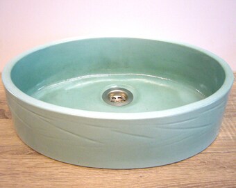 Handcrafted washbasin in a shiny mint glaze, highfired ceramic vessel