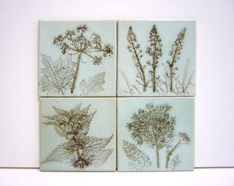 4 handmade tiles with imprints of flowers, highfired ceramic, 10x10 cm each