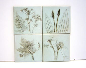 4 handmade tiles with imprints of flowers, highfired ceramic, 10x10 cm each