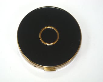 Polvera con espejo estilo Art Déco para mujer de Charles of the Ritz con borla; estuche vintage de 1959 en negro y dorado.